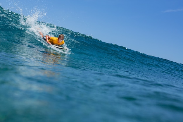 Surfer on a blue wave.