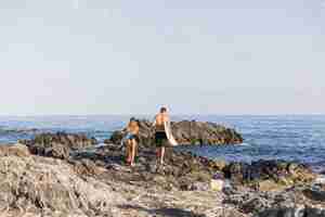 Free photo surfer couple at the beach