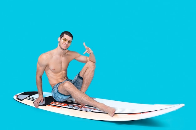 Surfer man posing on the board