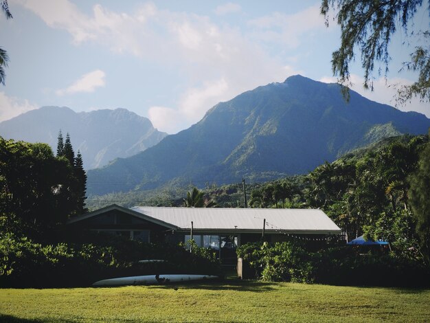 Surfing house beneath mountains in Hawaii