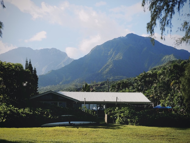 Surfing house beneath mountains in Hawaii