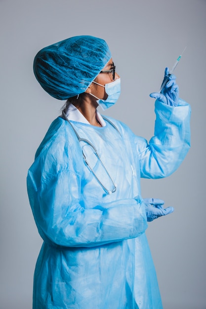 Surgeon looking at syringe