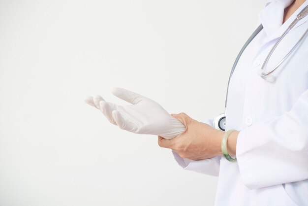 Surgeon putting on rubber glove