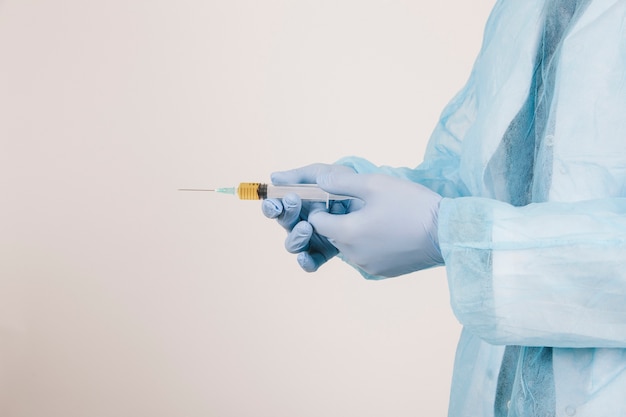 Surgeon's hands with a vaccine