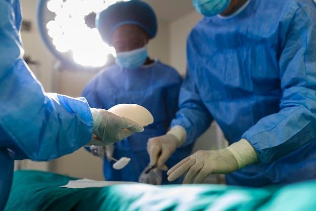 Surgeon team in uniform performs an operation on a patient at a cardiac surgery clinic Modern medicine a professional team of surgeons health