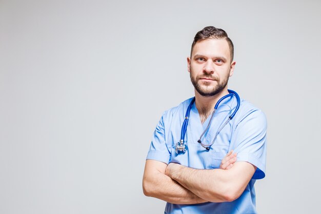 Surgeon with a stethoscope at the neck and arms crossed