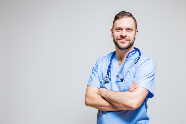 Surgeon with a stethoscope at the neck and arms crossed