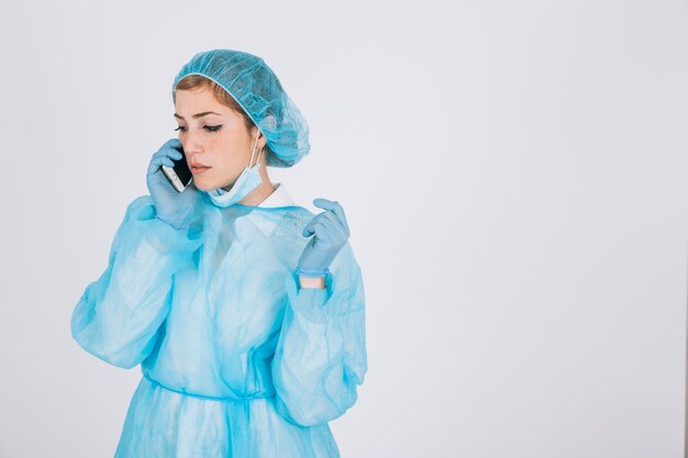 Surgeon working and talking on the phone
