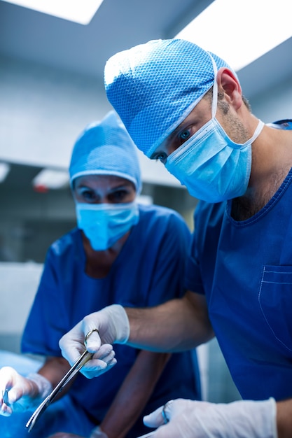 Surgeons performing operation in operation room