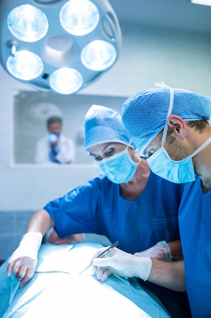 Surgeons performing operation in operation room