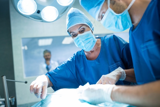 Surgeons performing operation in operation room