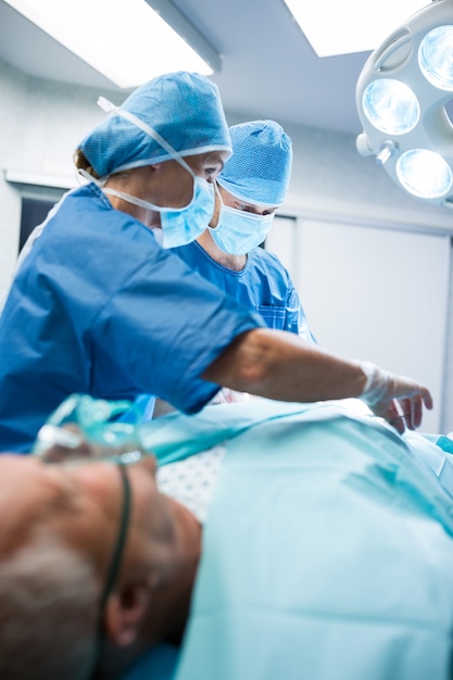 Surgeons performing operation in operation room