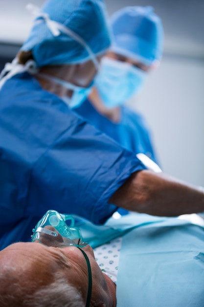 Surgeons performing operation in operation room