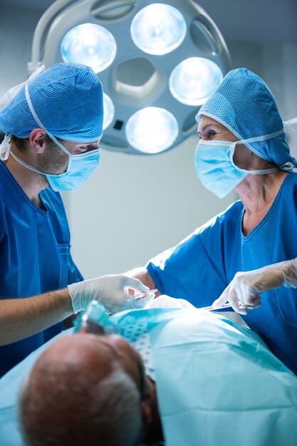 Surgeons performing operation in operation room