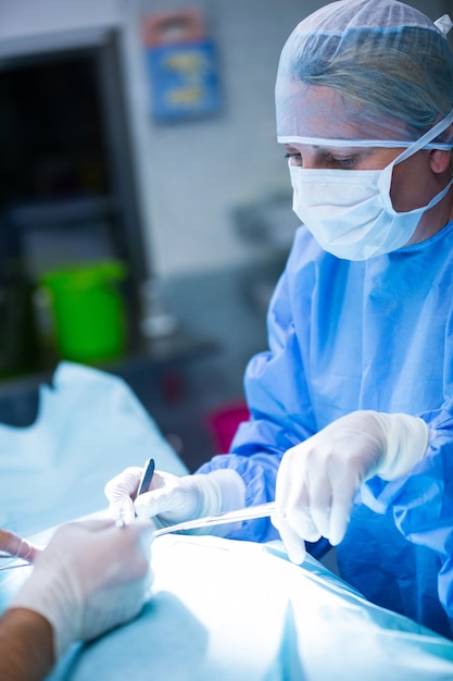 Surgeons performing operation in operation room