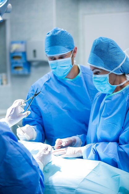 Surgeons performing operation in operation room