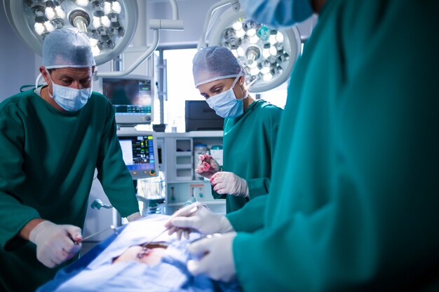 Surgeons performing operation in operation theater