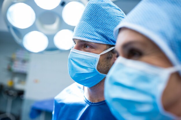 Surgeons standing in operation room