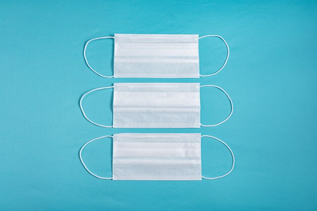 Surgical mask over minimalist blue background