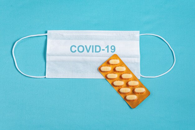 Surgical mask over minimalist blue background