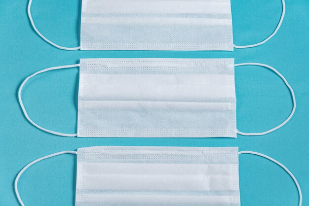 Surgical mask over minimalist blue background