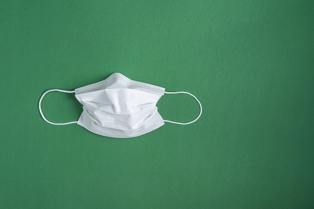 Free photo surgical mask over minimalist green background