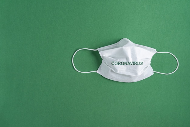 Free photo surgical mask over minimalist green background