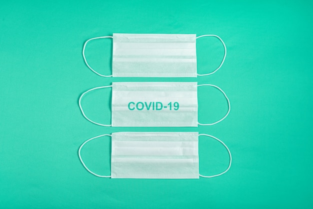 Surgical mask over minimalist green background