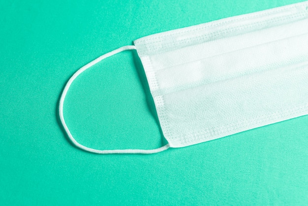 Free photo surgical mask over minimalist green background