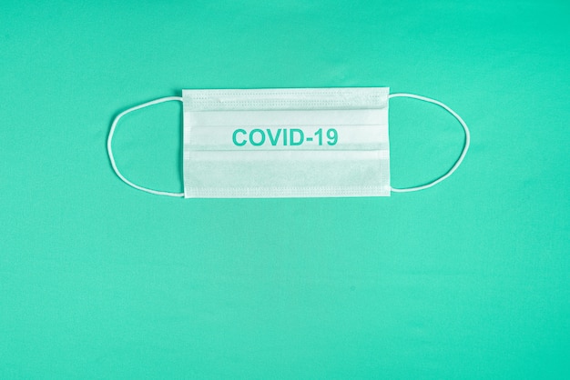 Free photo surgical mask over minimalist green background