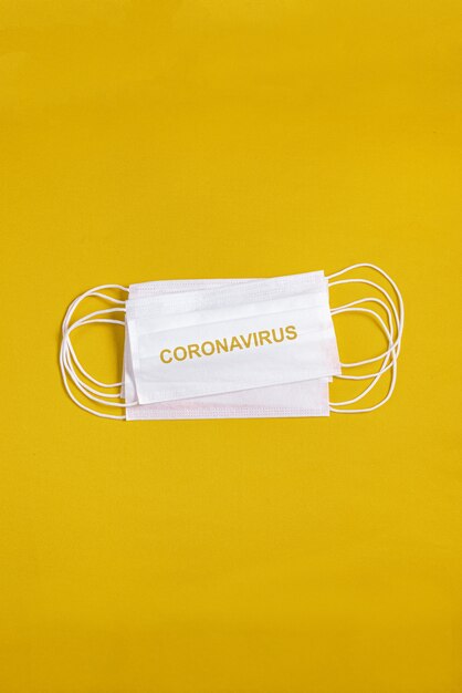 Surgical mask over minimalist orange background