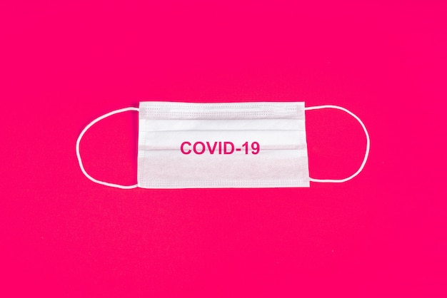 Surgical mask over minimalist orange background