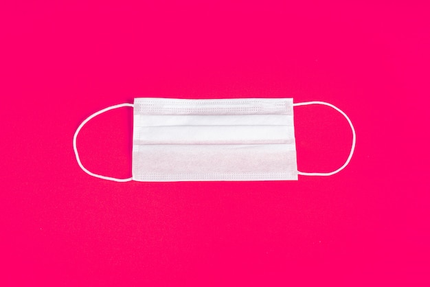 Surgical mask over minimalist orange background