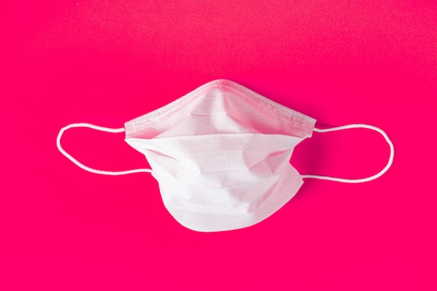 Surgical mask over minimalist orange background