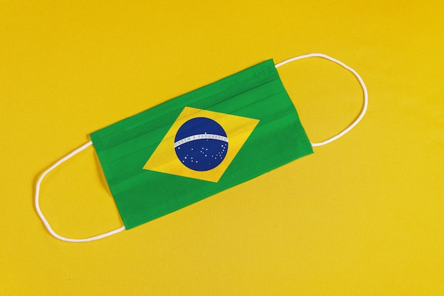 Free photo surgical mask on yellow background with brazilian flag