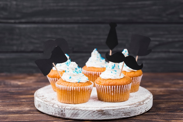 Surprise for father's day cupcakes on wooden board