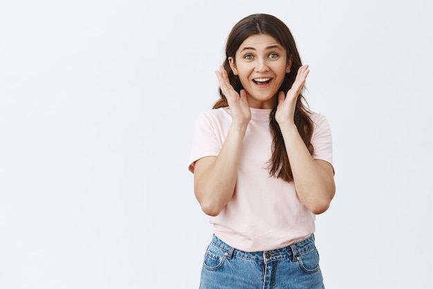 Surprised and amazed young brunette posing