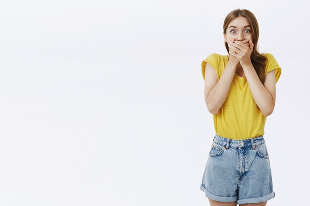 Surprised and amazed young girl gasping, looking impressed