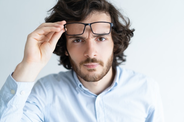 Surprised attractive young man staring at camera