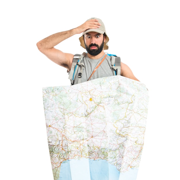 Free photo surprised backpacker with map over white background