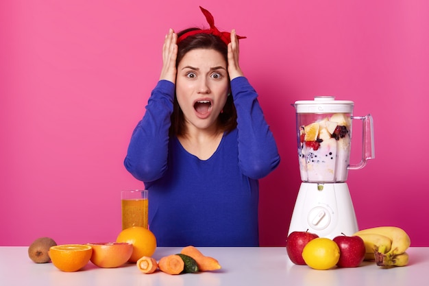 Free Photo | Portrait of beautiful woman using hand blender and in salmon  pink crop top and pants at kitchen ..