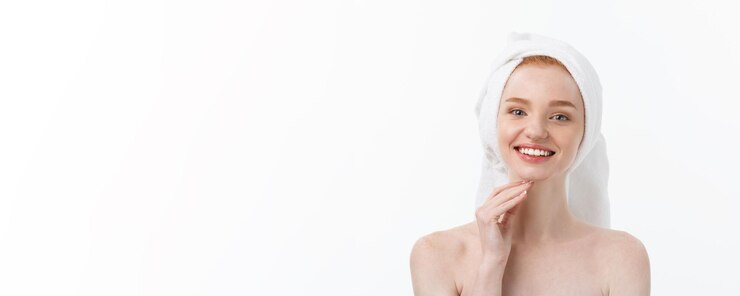 Free Photo surprised beautiful young woman after bath with a towel on her head isolated on white background ski