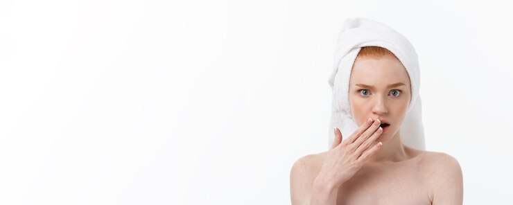 Free Photo surprised beautiful young woman after bath with a towel on her head isolated on white background ski