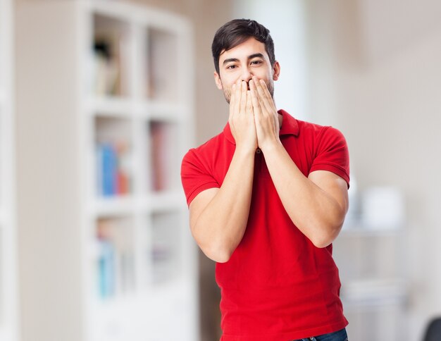 Surprised boy covering his mouth