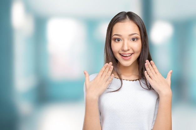 Surprised businesswoman with hands up amazed or shocked by unexpected news