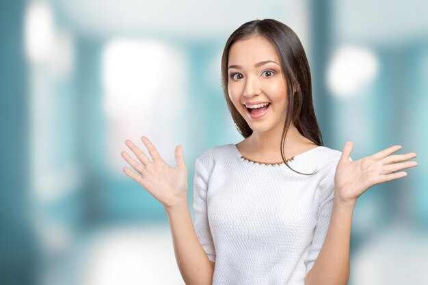 Surprised businesswoman with hands up amazed or shocked by unexpected news