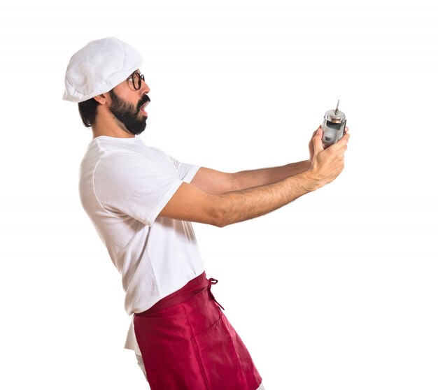 Surprised chef holding a clock