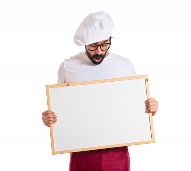 Surprised chef holding empty placard