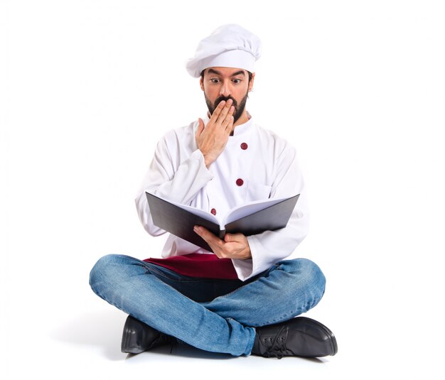 Surprised chef reading a book