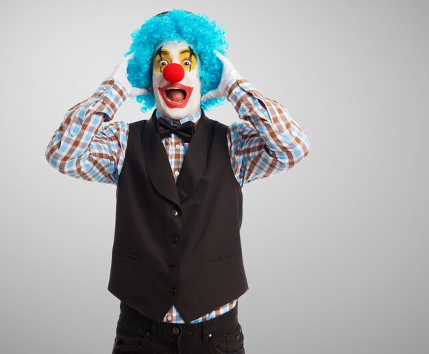 Surprised clown with hands on head